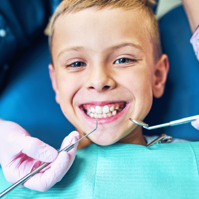 How to observe national children's dental health month 3 Little boy at the dentist, smiling, representing national children's dental health month